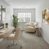 a living room with a desk and a chair