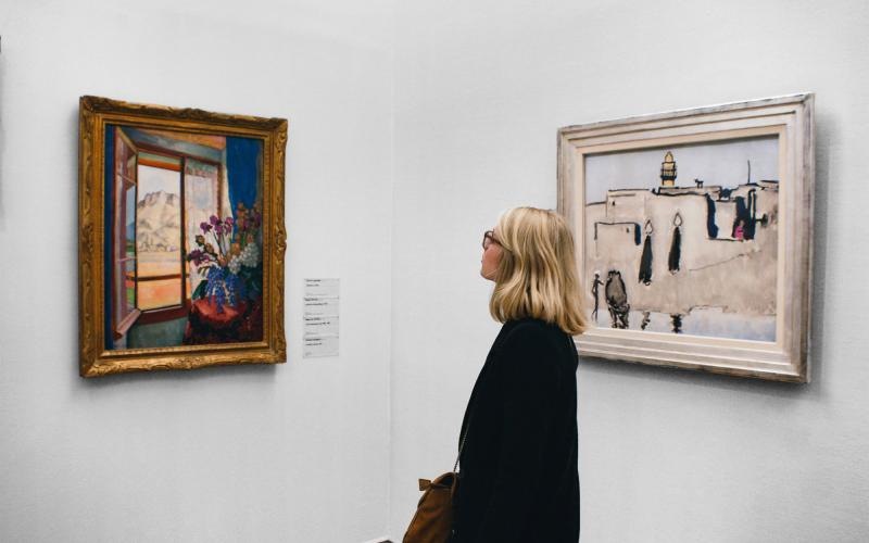 a person looking at art on the wall
